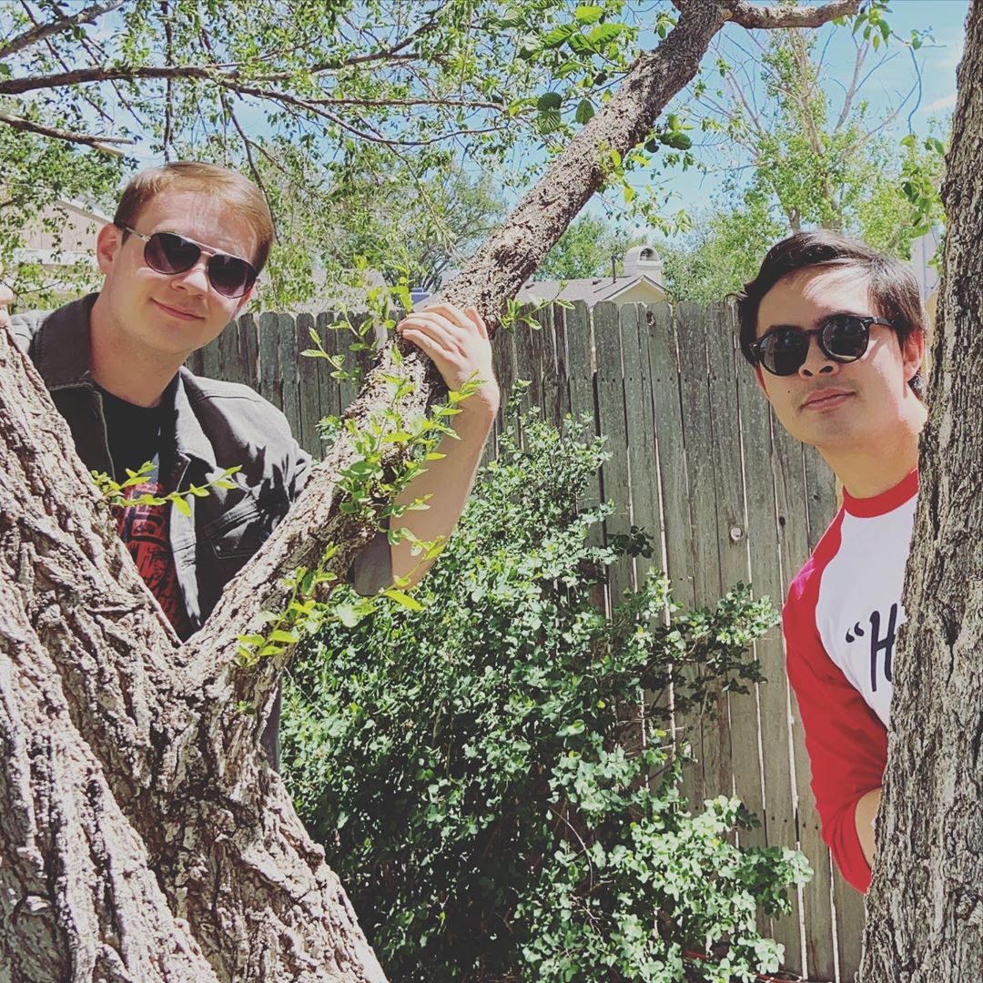 Steve and Kyle behind trees.